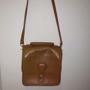 brown leather purse with gold clasp and detailing